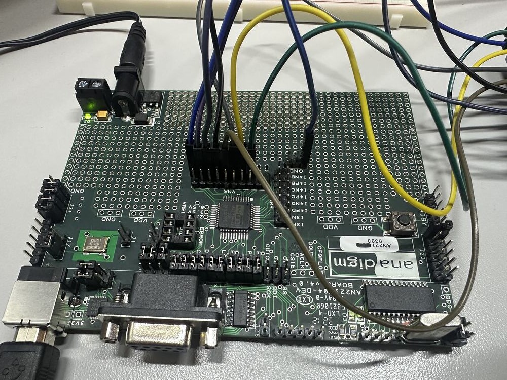 An Anadigm AN221E04 field programmable analog array on its development board, with jumper wires running to its header